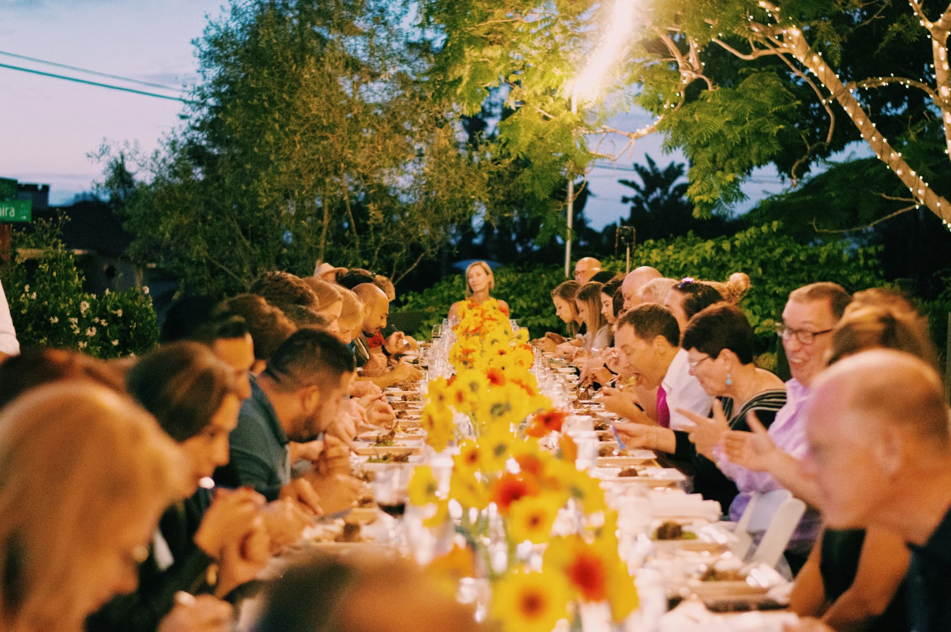 Guests gathered around a long outdoor table for the SIMA Shared Table series in the UK