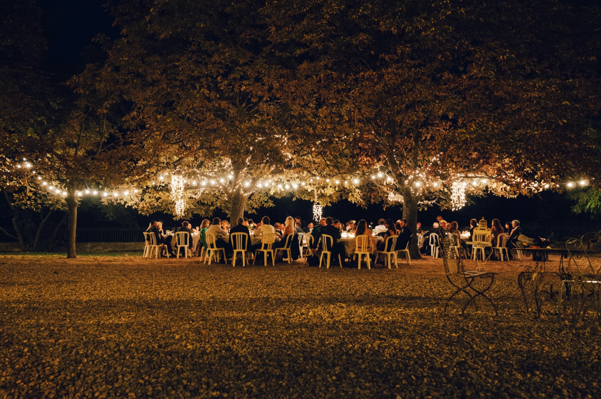 An outdoor SIMA dinner at night in the Italian countryside